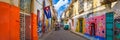 Urban scene with a cuban flag on a colorful street in Havana Royalty Free Stock Photo