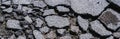 Panoramic view of an abstract cracked and crumbling asphalt road. texture background