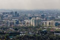 Panoramic view on Almaty city from mount Kok Tobe park. Cityscape at spring day. Haze smog above town, ecology problem Royalty Free Stock Photo