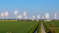 Panoramic view on alternative energy wind mills in a windpark with mulitple images blended