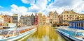 Amsterdam city panorama, colorful dancing houses over Damrak canal, Netherlands