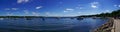 Panoramic view of anchored yachts in the clear blue lake