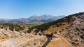 a panoramic view of the ancient centuries-old mills against the backdrop of mountains and olive groves of Crete filmed Royalty Free Stock Photo