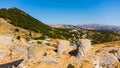 a panoramic view of the ancient centuries-old mills against the backdrop of mountains and olive groves of Crete filmed Royalty Free Stock Photo