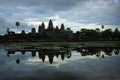 Panoramic view of Angkor Wat and its mirror reflection in the lake at sunrise time. Background of cloudy sky. Cambodia Royalty Free Stock Photo