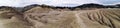 Panoramic view of an arid landscape at the Mud Volcanoes