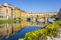 Panoramic view of the Arno River and stone medieval bridge Ponte Vecchio with beautiful reflection of colorful houses, Florence Royalty Free Stock Photo