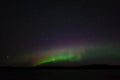 Panoramic view of the aurora borealis. Polar lights in the night starry sky over the lake Royalty Free Stock Photo