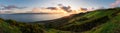 Panoramic view of an Azores sunset across the hilly SÃÂ£o Jorge countryside with Pico Island across the sea in the background