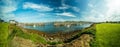 Panoramic view of bay with moored boats seen from peaceful shore, Ireland