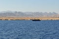 Panoramic view of the bay. A ship with masts is sailing along the bay.