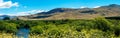 Panoramic view of a beautiful afternoon in a valley with a river and the Lanin volcano in the background in spring. Neuquen,