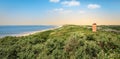 Coastal landscape with lighthouse in the dunes at the beautiful beach of Dishoek, Zeeland, The Netherlands. Royalty Free Stock Photo