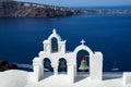 Panoramic view of beautiful blue Aegean sea, sailing ship and caldera from Oia village with white church roof foreground Royalty Free Stock Photo