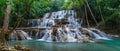 Panoramic view of a beautiful deep forest waterfall in Thailand, surrounded by lush greenery. Ai Generated Royalty Free Stock Photo