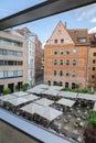 Panoramic view of beautiful houses and rooftops of old city through glass windows of modern art Neues Museum of Nurnberg