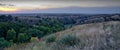 Panoramic view of a beautiful landscape with mountain ranges under the sunset sky Royalty Free Stock Photo