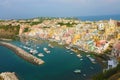 Panoramic view of beautiful Procida in sunny summer day. Colorful houses, cafes and restaurants, fishing boats and yachts in Royalty Free Stock Photo