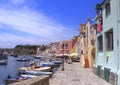 Panoramic view of beautiful Procida in sunny summer day. Colorful houses, cafes and restaurants, fishing boats and yachts in Marin Royalty Free Stock Photo