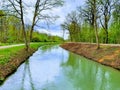 Panoramic view of beautiful scenery in the Alps with clear lake, green meadow, blooming flowers, Royalty Free Stock Photo