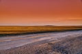 Panoramic view: beautiful spring landscape: spring huge great steppe wakes up from winter sleep - snow and ice just melted, sunset