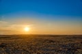 Panoramic view: beautiful spring landscape: spring huge great steppe wakes up from winter sleep - snow and ice just melted, sunset