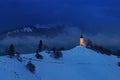 Panoramic view of beautiful winter wonderland mountain scenery in the Alps with pilgrimage church of Jamnik and famous Julian Alps Royalty Free Stock Photo