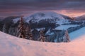 Panoramic view of beautiful winter wonderland mountain scenery in evening light at sunset. Mountains above the clouds. Christmas Royalty Free Stock Photo