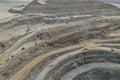 Panoramic view of benches in the process of drilling and placement of explosive charges for large-scale blasting in an open-pit Royalty Free Stock Photo