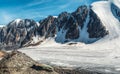 Panoramic view of the Big Aktru Glacier, high in the mountains, covered by snow and ice. Altai winter landscape