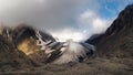 Panoramic view of the Big Aktru Glacier, high in the mountains, covered by snow and ice. Dramatic Altai winter landscape