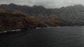 Panoramic view of the big mountains off the coast of the Atlantic Ocean on a cloudy day. Bird`s eye view. Agaete, Gran