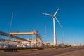 Panoramic view big wind turbines to generate electrical power as green ecofriendly energy and industrial plant at warm sunset
