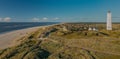 Panoramic view of BlÃÂ¥vand lighthouse on wide dune of BlÃÂ¥vandshuk with beach view on the west coast of Jutland Royalty Free Stock Photo