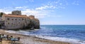 Panorama of Budva Old Town Citadel and Adriatic Sea with an outdoor cafe on Richard s Head beach in Montenegro, Balkans Royalty Free Stock Photo