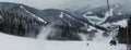 Panoramic view of Bukovel ski resort from ski lift, snow, mountains and trees on the background.