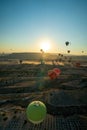 Panoramic view of bunch of colorful hot air balloon flying against sunrise in Cappadocia, Turkey in love valley located in Goreme Royalty Free Stock Photo
