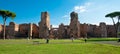 Panoramic view of Caracalla springs ruins from grounds with turists at Rome