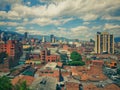 Panoramic of downtown Medellin with tall buildings, mud roofs and lots of color