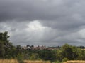 Panoramic view of the Christian Church with the bell tower and the Greek village on the island of Evia in a summer storm with blac Royalty Free Stock Photo