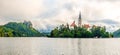 Panoramic view at the Church of Assumption of St.Mary at the Island of Bled Lake with Bled Castle in background in Slovenia