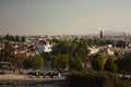Panoramic view churches that mix between houses and buildings in the city of Puebla among trees Mexico