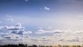 Panoramic view of city background blue sky with white huge single floating clouds against blue sky Royalty Free Stock Photo