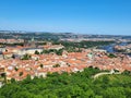 Panoramic view of the city with orange tiled roofs next to the forest Royalty Free Stock Photo