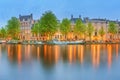 Panoramic view and cityscape of Amsterdam with boats, old buildings and Amstel river, Holland, Netherlands Royalty Free Stock Photo