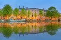 Panoramic view and cityscape of Amsterdam with boats, old buildings and Amstel river, Holland, Netherlands Royalty Free Stock Photo