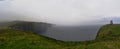 Panoramic view of the cliff of Moher with rain and fog Royalty Free Stock Photo