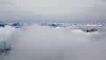 Panoramic view on clouds and top of the alp mountains in Switzerland Royalty Free Stock Photo