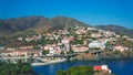 A panoramic view of a coastal port city from a mountain summit, where the convergence of land and sea creates a mesmerizing specta Royalty Free Stock Photo