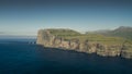 Panoramic view on coastline of island Eysturoy with Risin og Kellingin rocks on Faroe Islands during the day with sun and blue sky